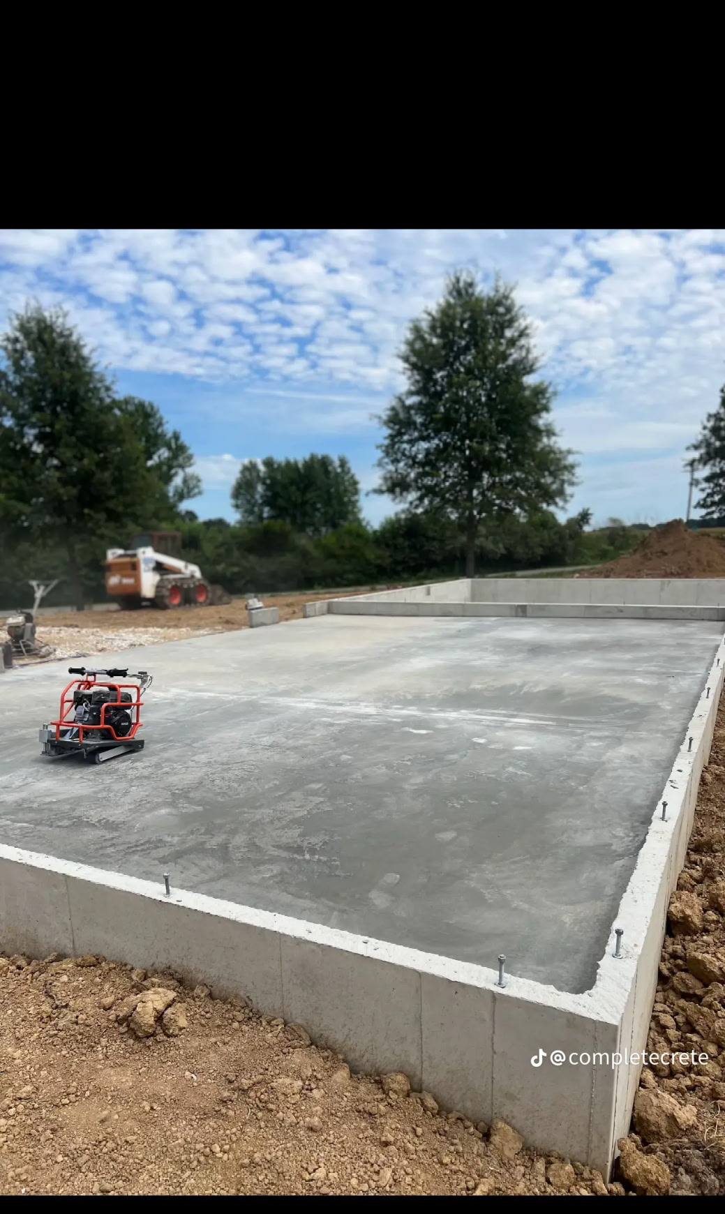 Ride-on power trowel finishing a new foundation floor