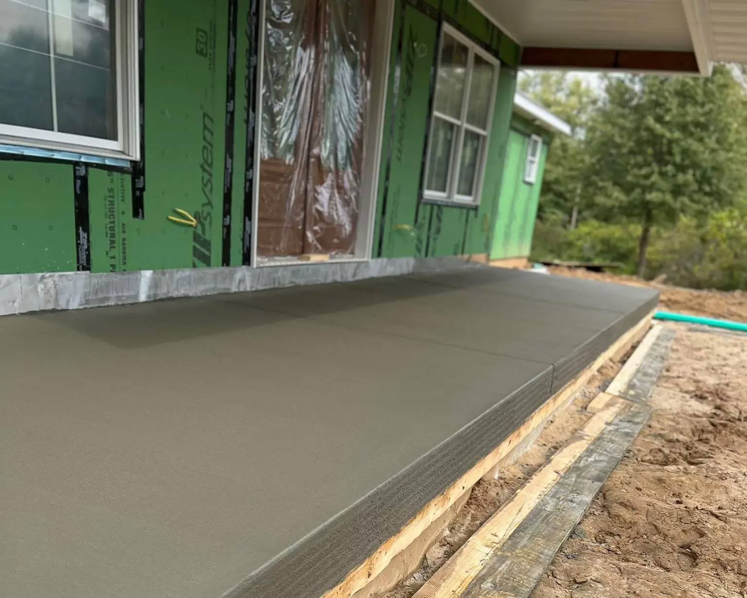 Freshly poured concrete porch slab on new construction