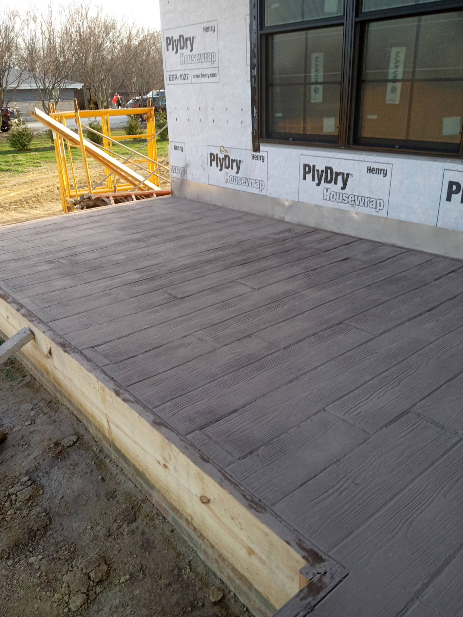 Wood-plank pattern stamped concrete patio, gray finish
