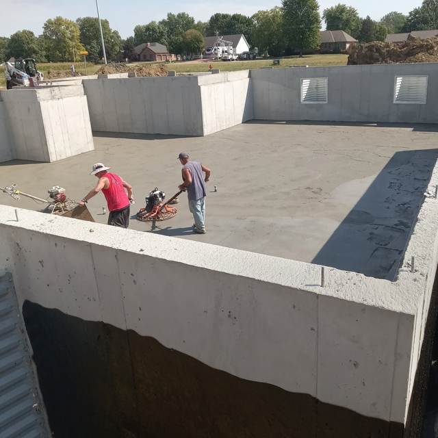 Crew finishing a basement floor pour, aerial view