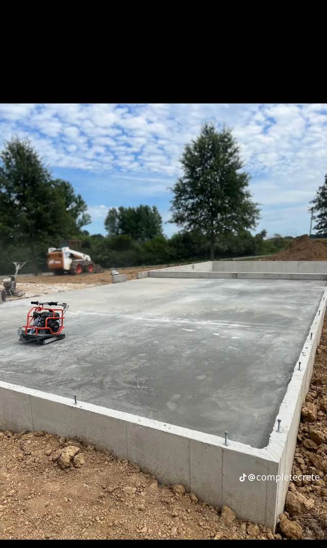 Ride-on power trowel finishing a new foundation floor