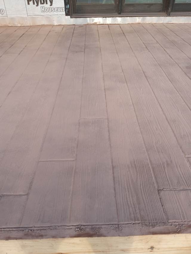 Wood-plank stamped concrete close detail, tan finish